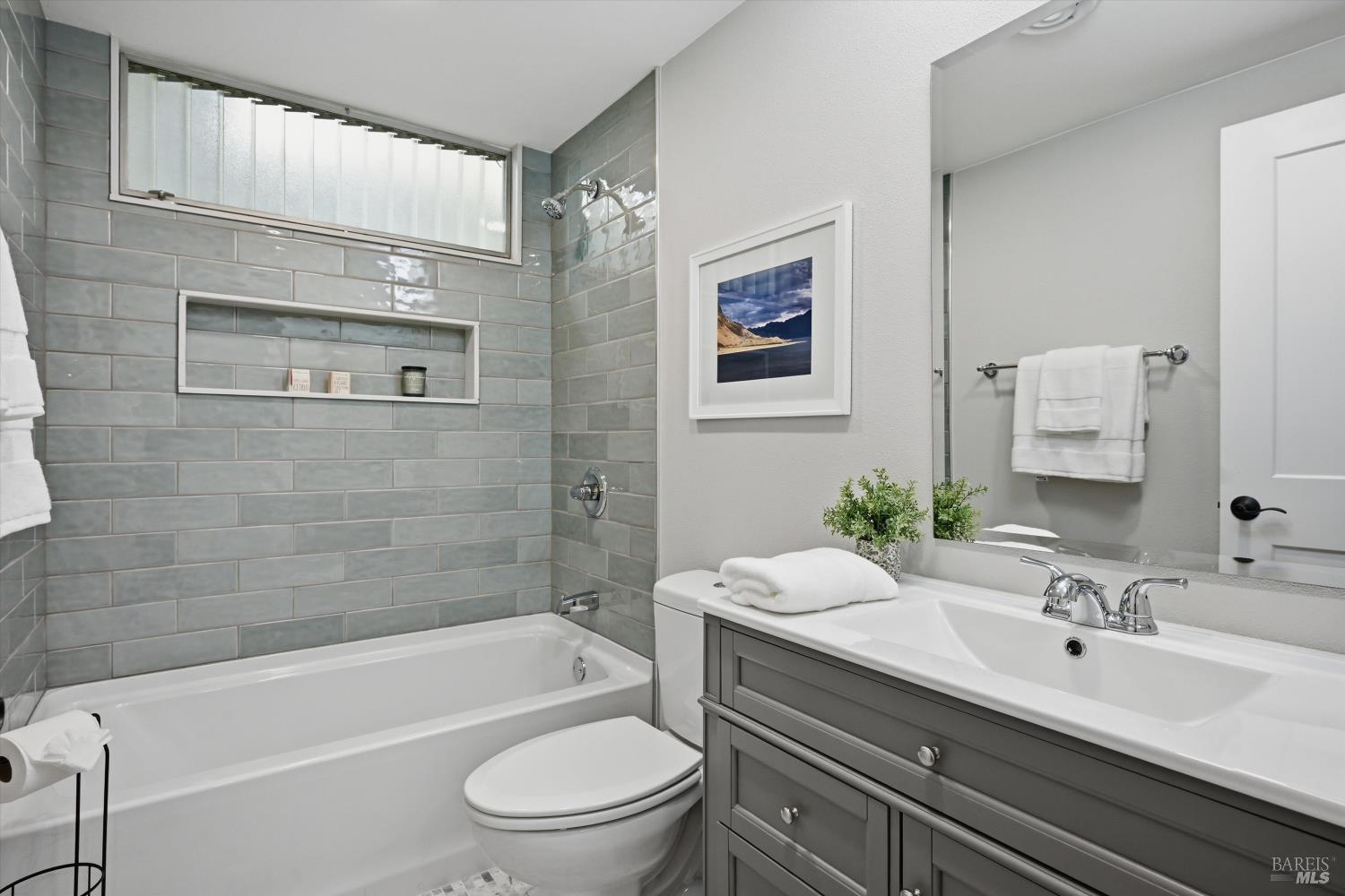 23 Valley Green Street Santa Rosa, CA 95409 - Photo 15 of 58 a bathroom with a toilet a sink a mirror a bathtub and shower