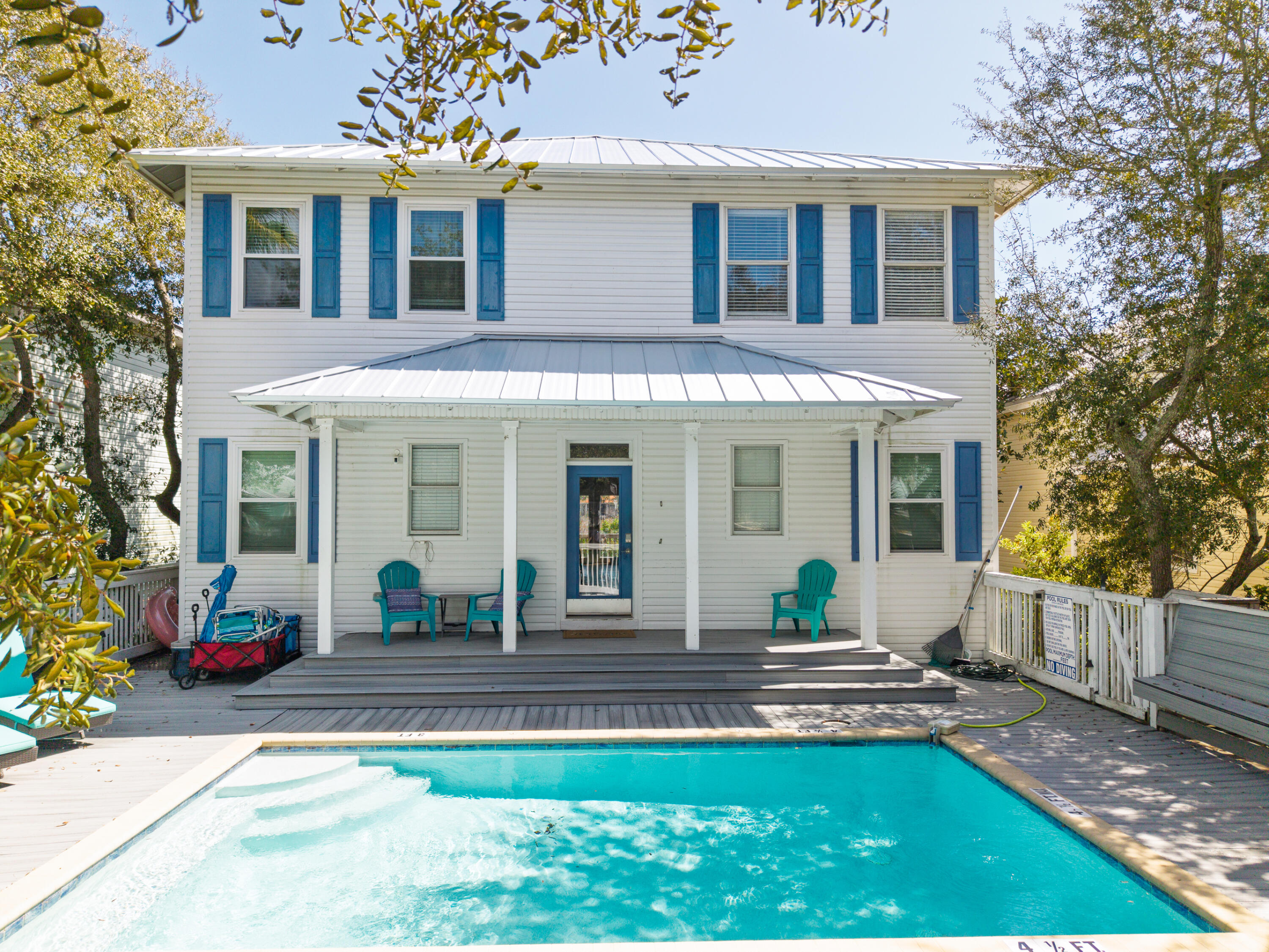 a view of a house with a yard chairs and a table