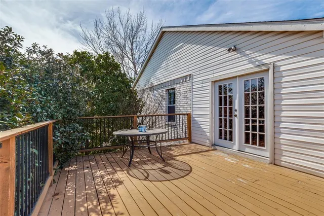 a view of a roof deck with wooden floor and fence