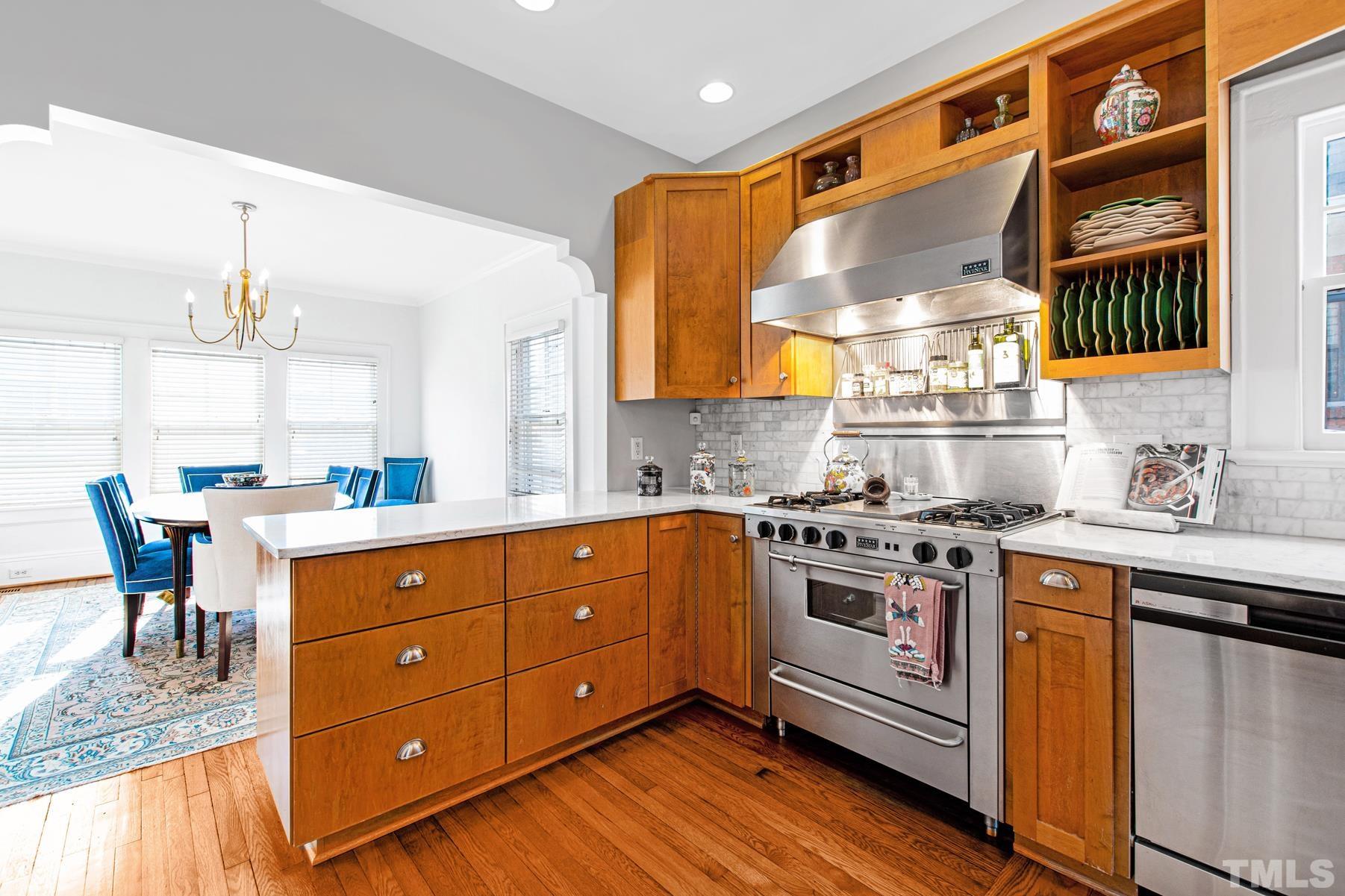 1835 White Oak Road Raleigh, NC 27608 - Photo 14 of 35 a kitchen with a stove a sink and a refrigerator