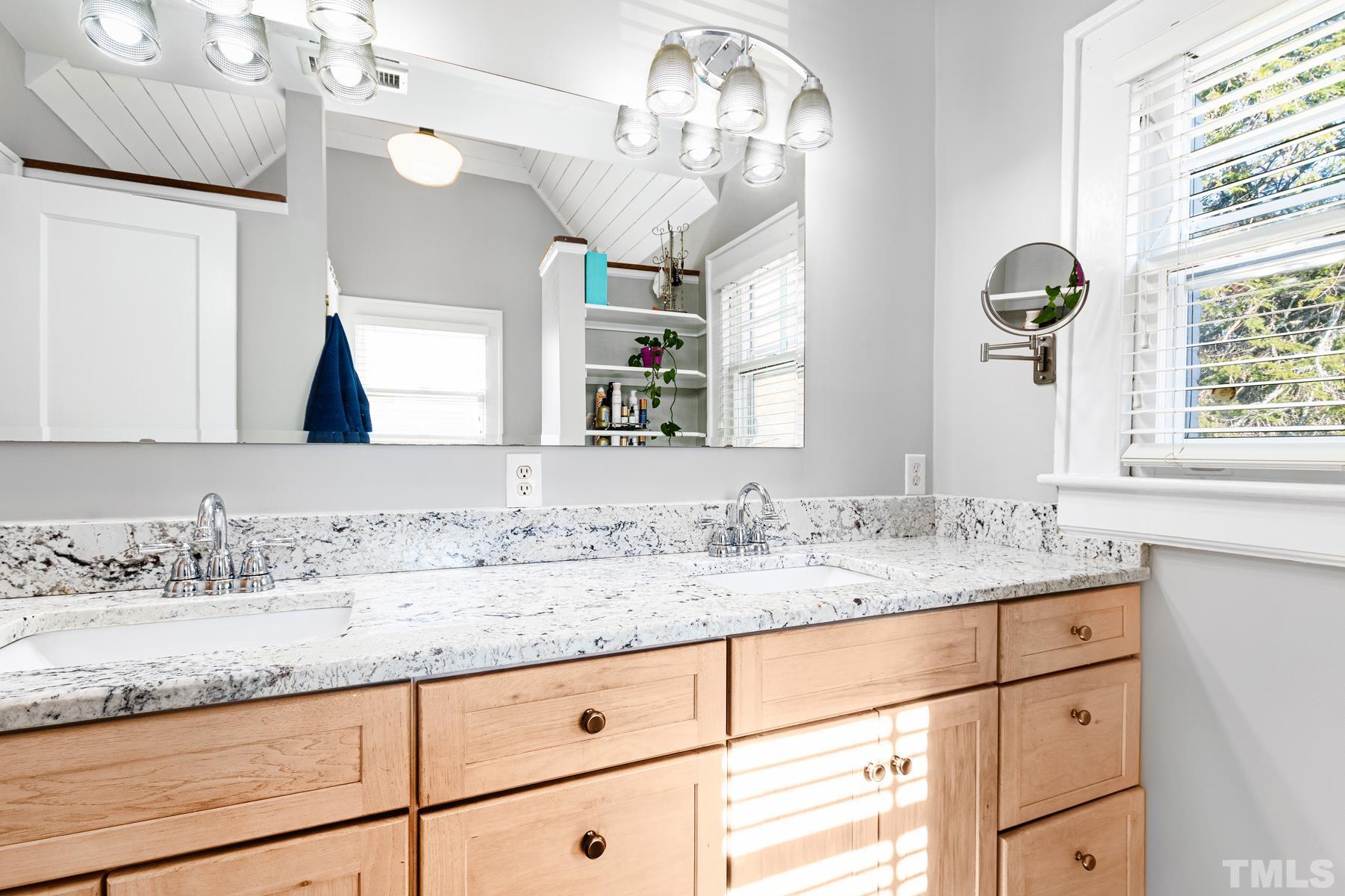1835 White Oak Road Raleigh, NC 27608 - Photo 22 of 35 a bathroom with a granite countertop sink mirror and window