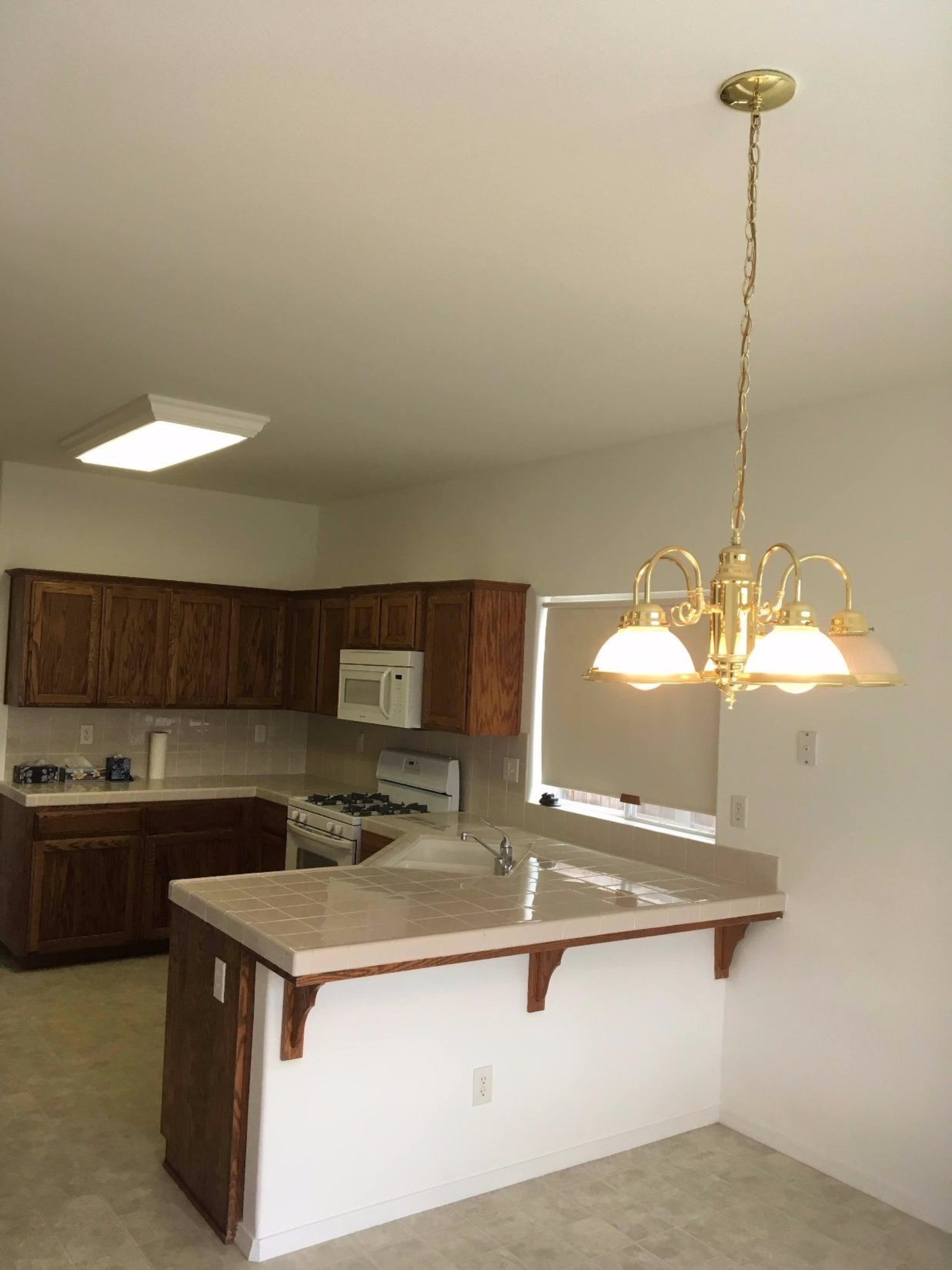 979 Maple Avenue Fowler, CA 93625 - Photo 7 of 10 a kitchen with stainless steel appliances granite countertop a sink and a refrigerator