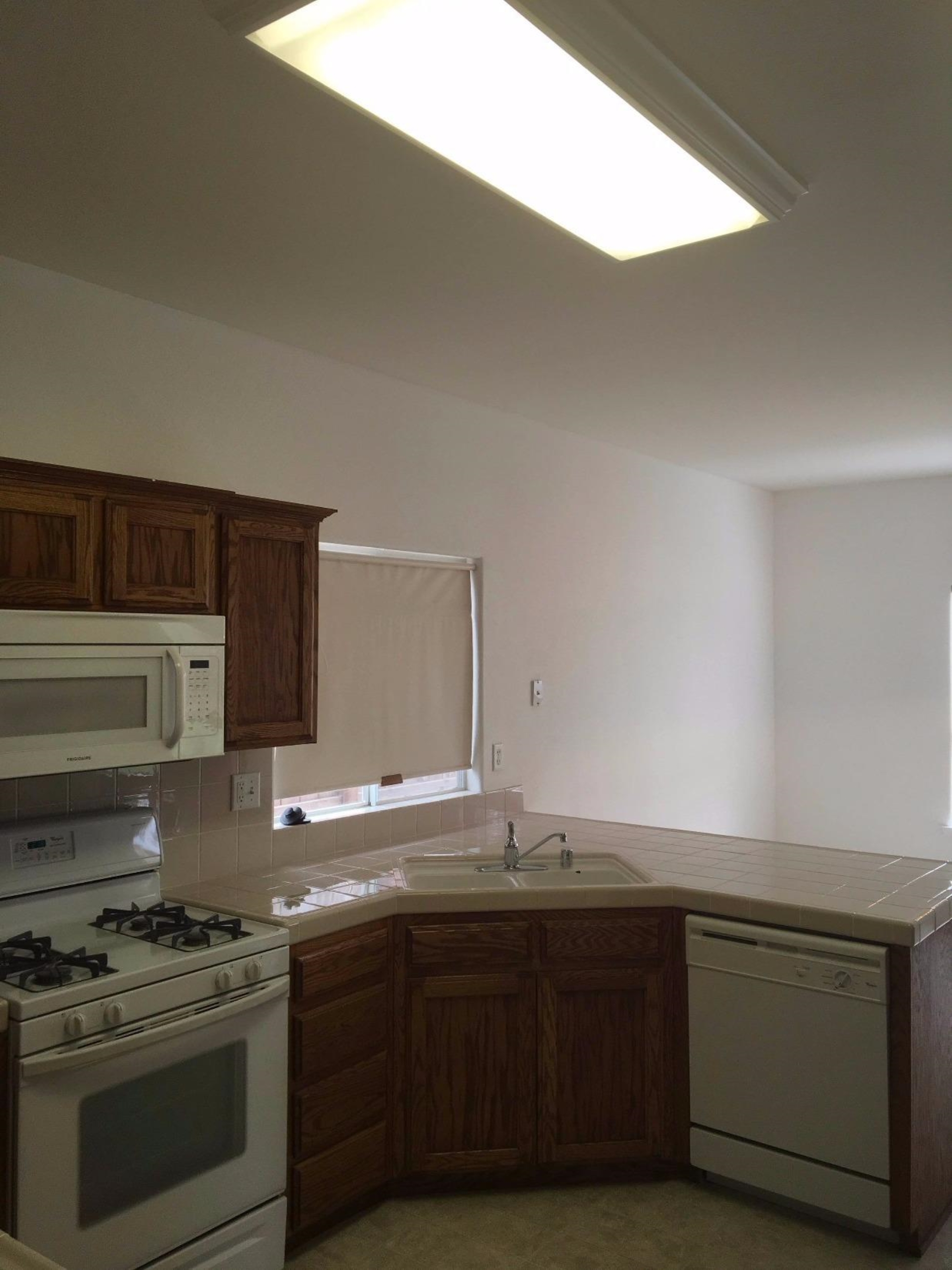 979 Maple Avenue Fowler, CA 93625 - Photo 9 of 10 a kitchen with stainless steel appliances granite countertop a stove a sink and a microwave
