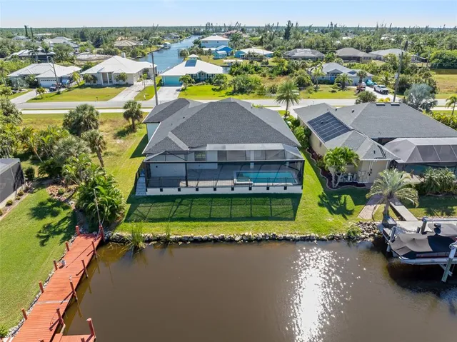 a aerial view of a house with a garden and lake view