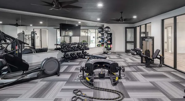 a room with gym equipment and a large window