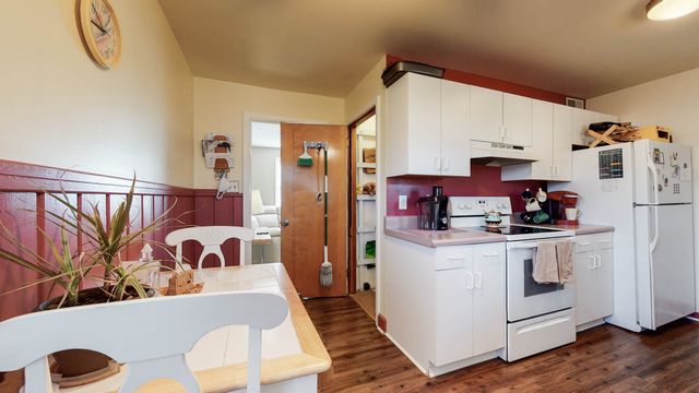 a kitchen with stainless steel appliances granite countertop a refrigerator and a stove