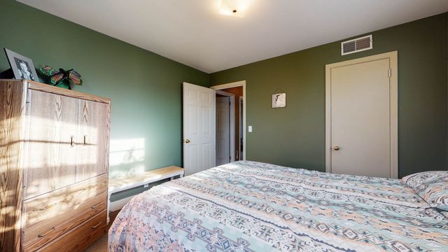 a bedroom with a bed and a large window