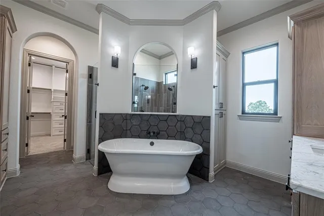 an empty room with windows and chandelier