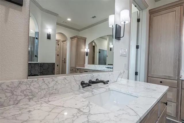 a bathroom with a double vanity sink mirror and bathtub