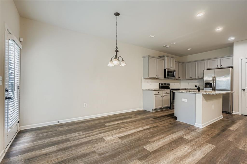 1901 Creel Lane Atlanta, GA 30349 - Photo 11 of 28 a kitchen with granite countertop white cabinets and white appliances