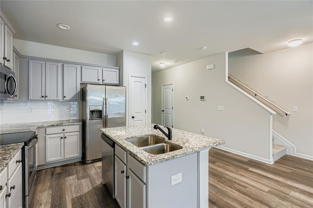 1901 Creel Lane Atlanta, GA 30349 - Photo 13 of 28 a kitchen that has a sink a refrigerator and cabinets