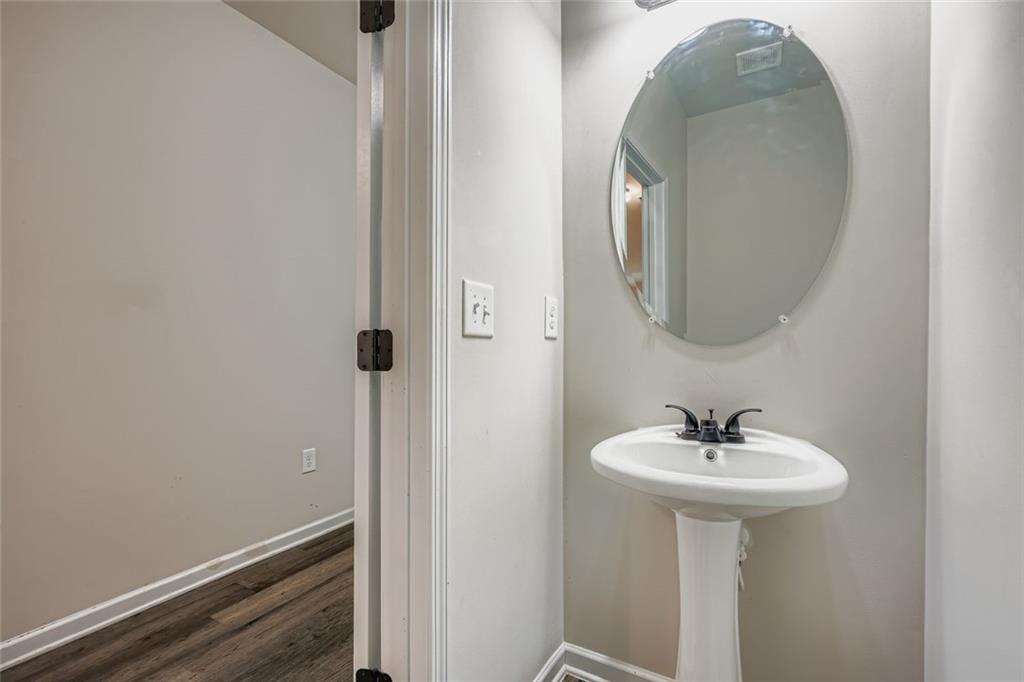 1901 Creel Lane Atlanta, GA 30349 - Photo 16 of 28 a bathroom with a sink and a mirror