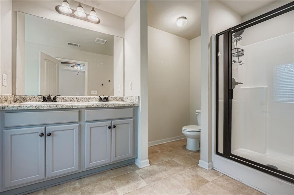 1901 Creel Lane Atlanta, GA 30349 - Photo 19 of 28 a bathroom with a granite countertop sink toilet and mirror
