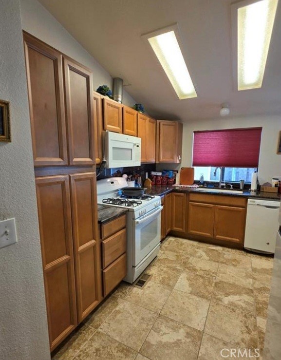 27250 Murrieta Road, Unit 390 Menifee, CA 92586 - Photo 12 of 30 a kitchen with stainless steel appliances a refrigerator sink and microwave