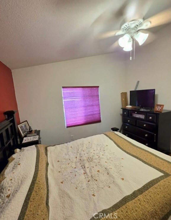 27250 Murrieta Road, Unit 390 Menifee, CA 92586 - Photo 17 of 30 a bedroom with a bed and a dresser