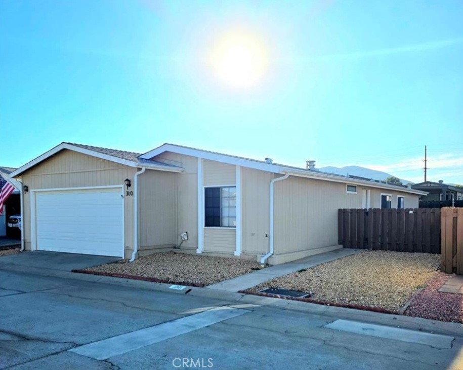 27250 Murrieta Road, Unit 390 Menifee, CA 92586 - Photo 2 of 30 a view of a house with a wooden fence