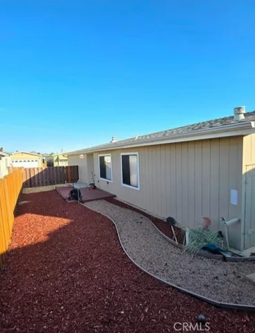 a backyard of a house with barbeque oven table and chairs