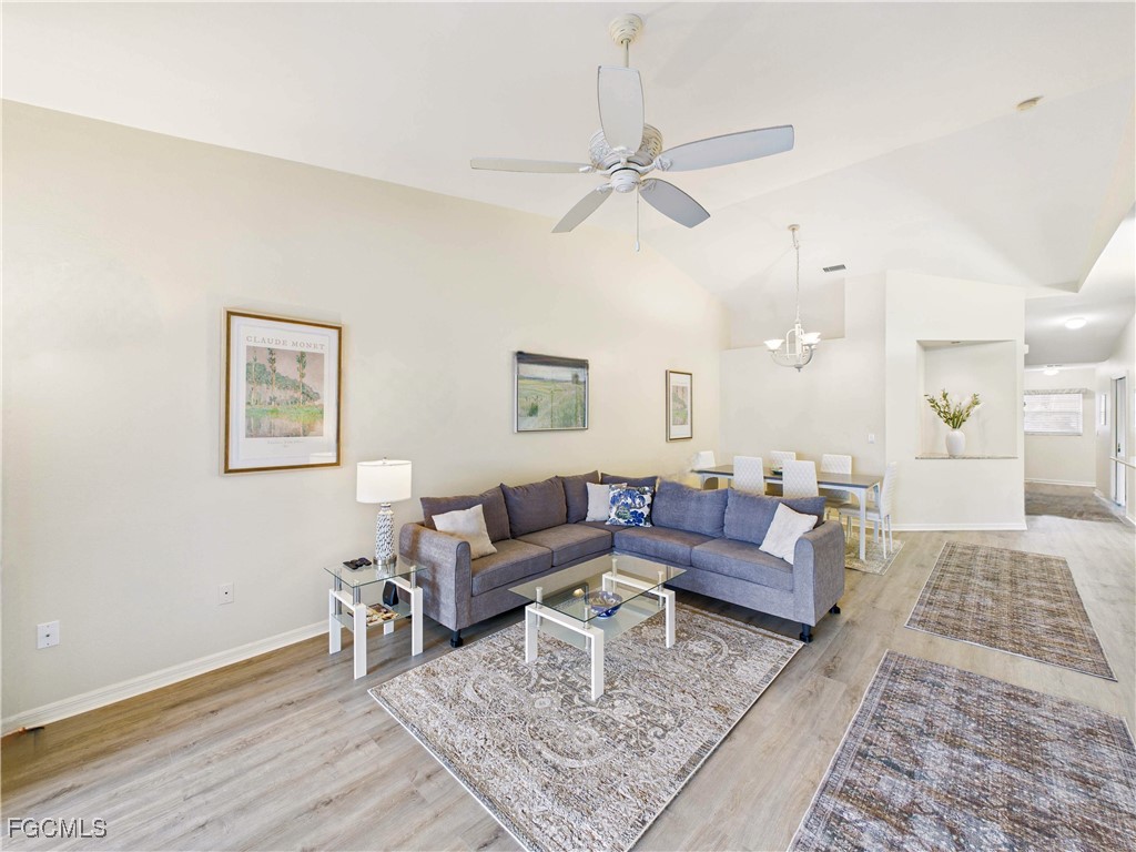 7435 Plumbago Bridge Road, Unit K201 Naples, FL 34109 - Photo 13 of 35 a living room with furniture and a rug