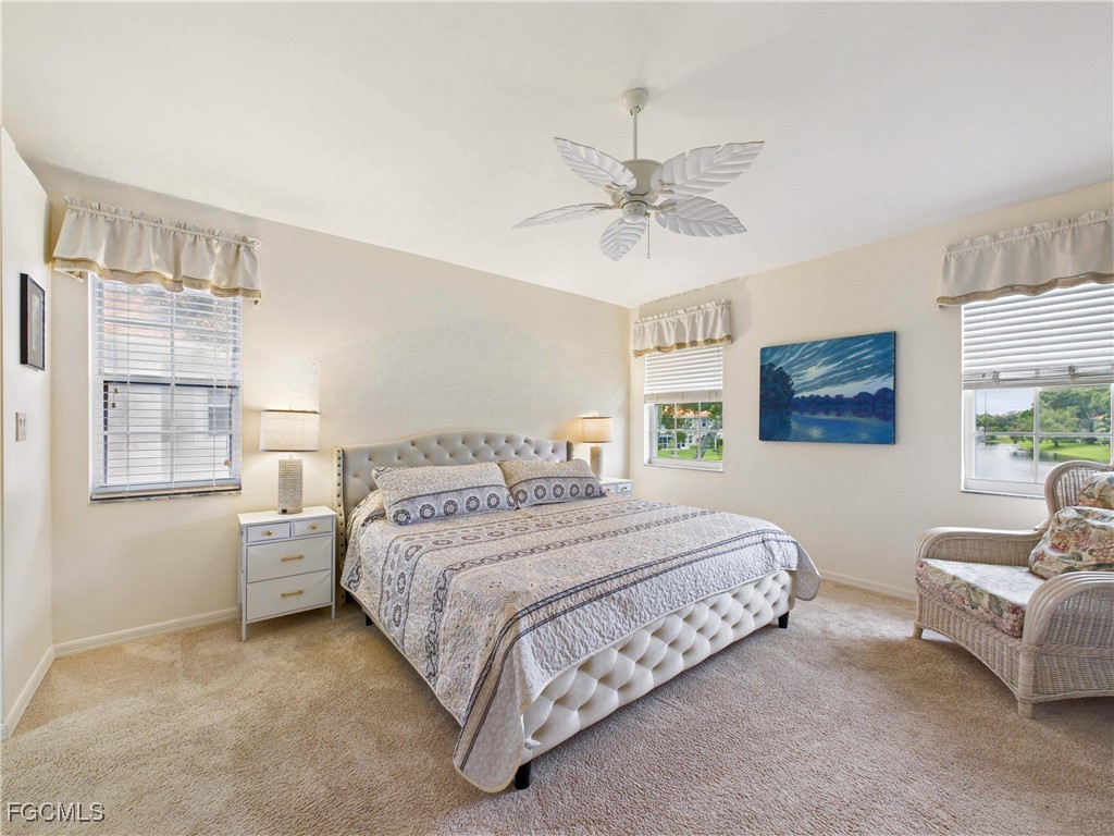 7435 Plumbago Bridge Road, Unit K201 Naples, FL 34109 - Photo 17 of 35 a spacious bedroom with a bed and a couch