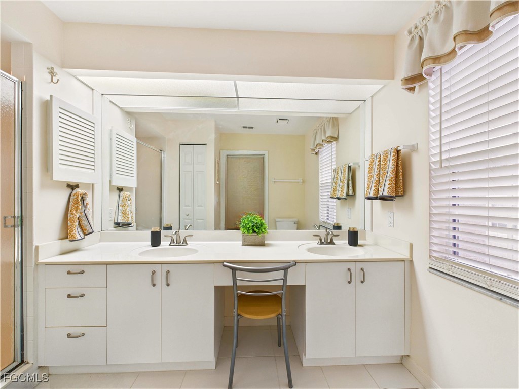 7435 Plumbago Bridge Road, Unit K201 Naples, FL 34109 - Photo 24 of 35 a bathroom with a sink and a mirror