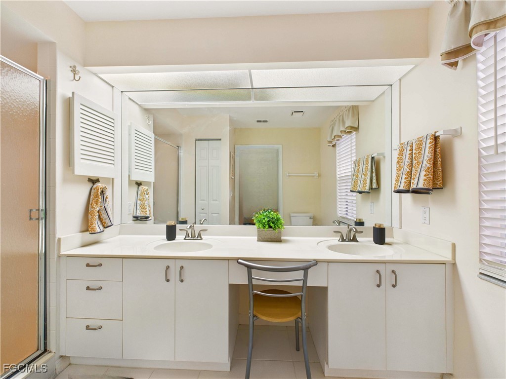 7435 Plumbago Bridge Road, Unit K201 Naples, FL 34109 - Photo 25 of 35 a bathroom with a double vanity sink mirror and