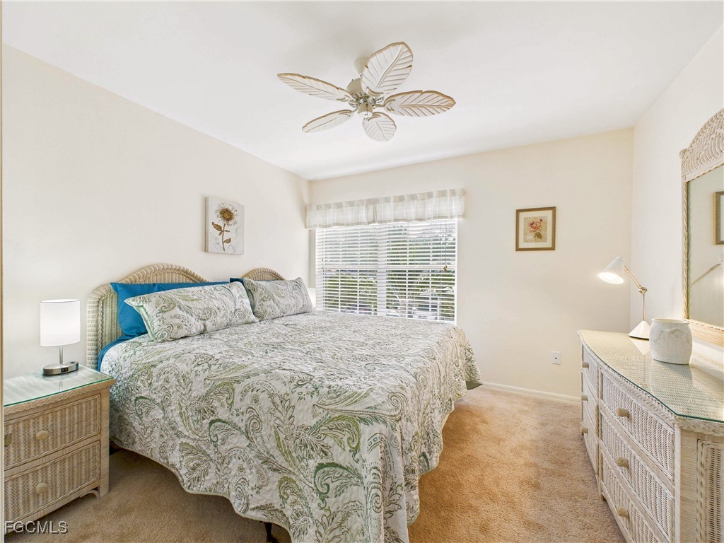 7435 Plumbago Bridge Road, Unit K201 Naples, FL 34109 - Photo 28 of 35 a spacious bedroom with a bed and a window