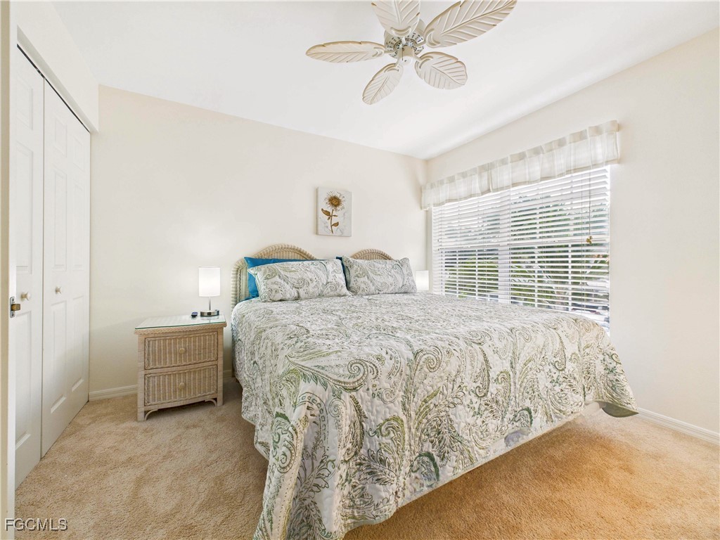 7435 Plumbago Bridge Road, Unit K201 Naples, FL 34109 - Photo 30 of 35 a bedroom with a bed and a window