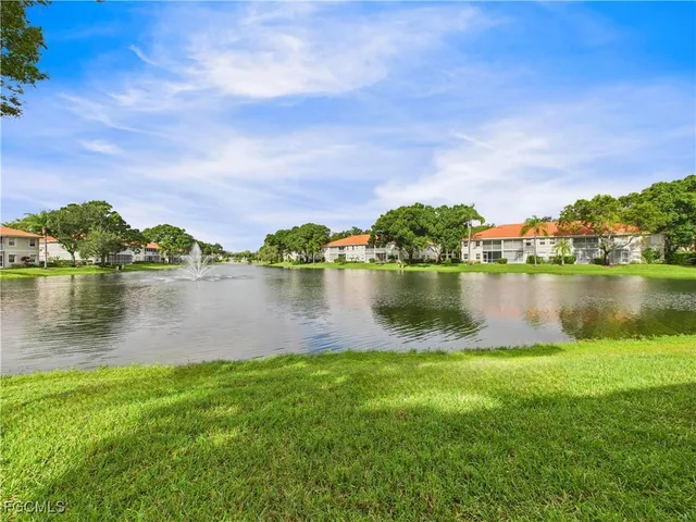 a view of a lake with houses in the background