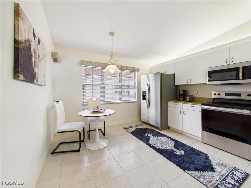 7435 Plumbago Bridge Road, Unit K201 Naples, FL 34109 - Photo 8 of 35 a kitchen with a refrigerator a sink dishwasher a stove and a refrigerator with wooden floor