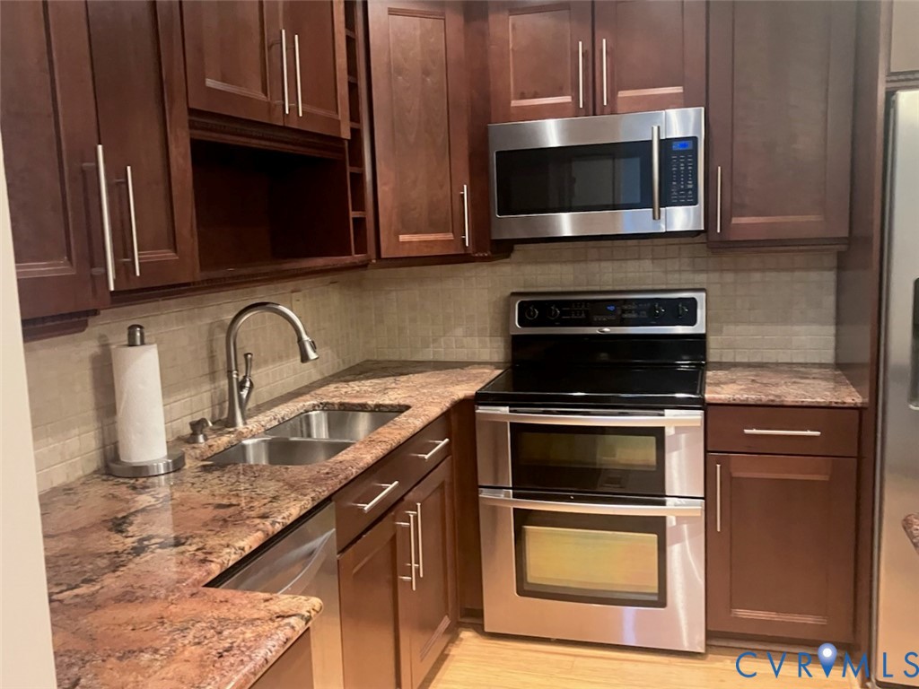 3901 McTyres Cove Court Midlothian, VA 23112 - Photo 3 of 11 a kitchen with granite countertop a stove and a microwave