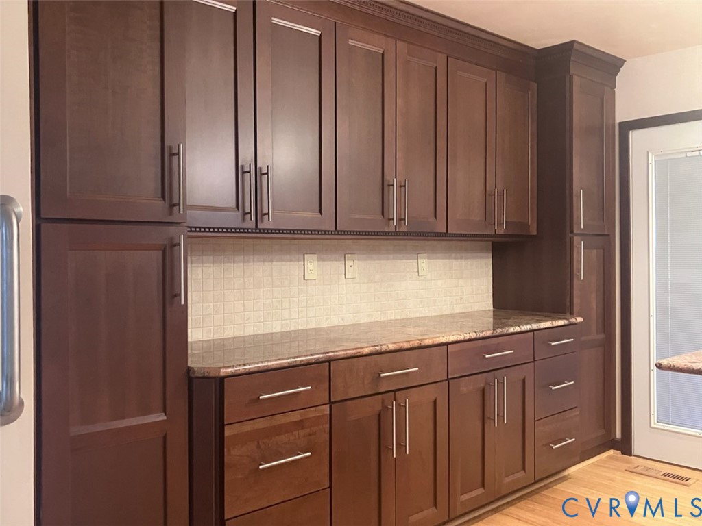 3901 McTyres Cove Court Midlothian, VA 23112 - Photo 4 of 11 a kitchen with granite countertop wooden cabinets and granite counter tops