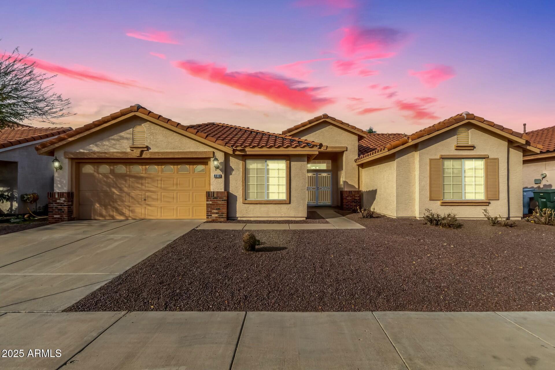 4010 West Wethersfield Road Phoenix, AZ 85029 - Photo 1 of 43 a front view of a house with a yard and garage