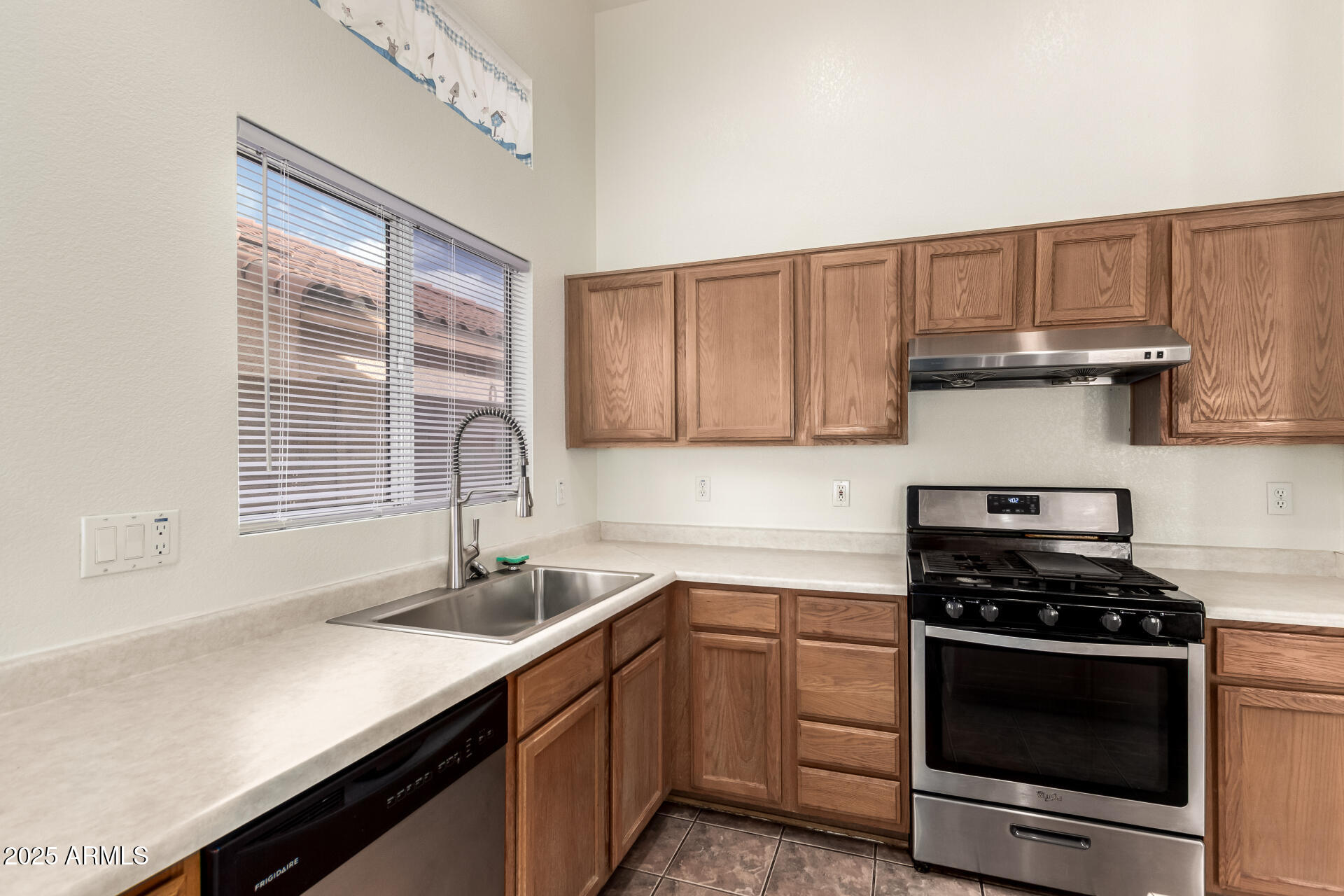 4010 West Wethersfield Road Phoenix, AZ 85029 - Photo 13 of 43 a kitchen with a sink stove and cabinets