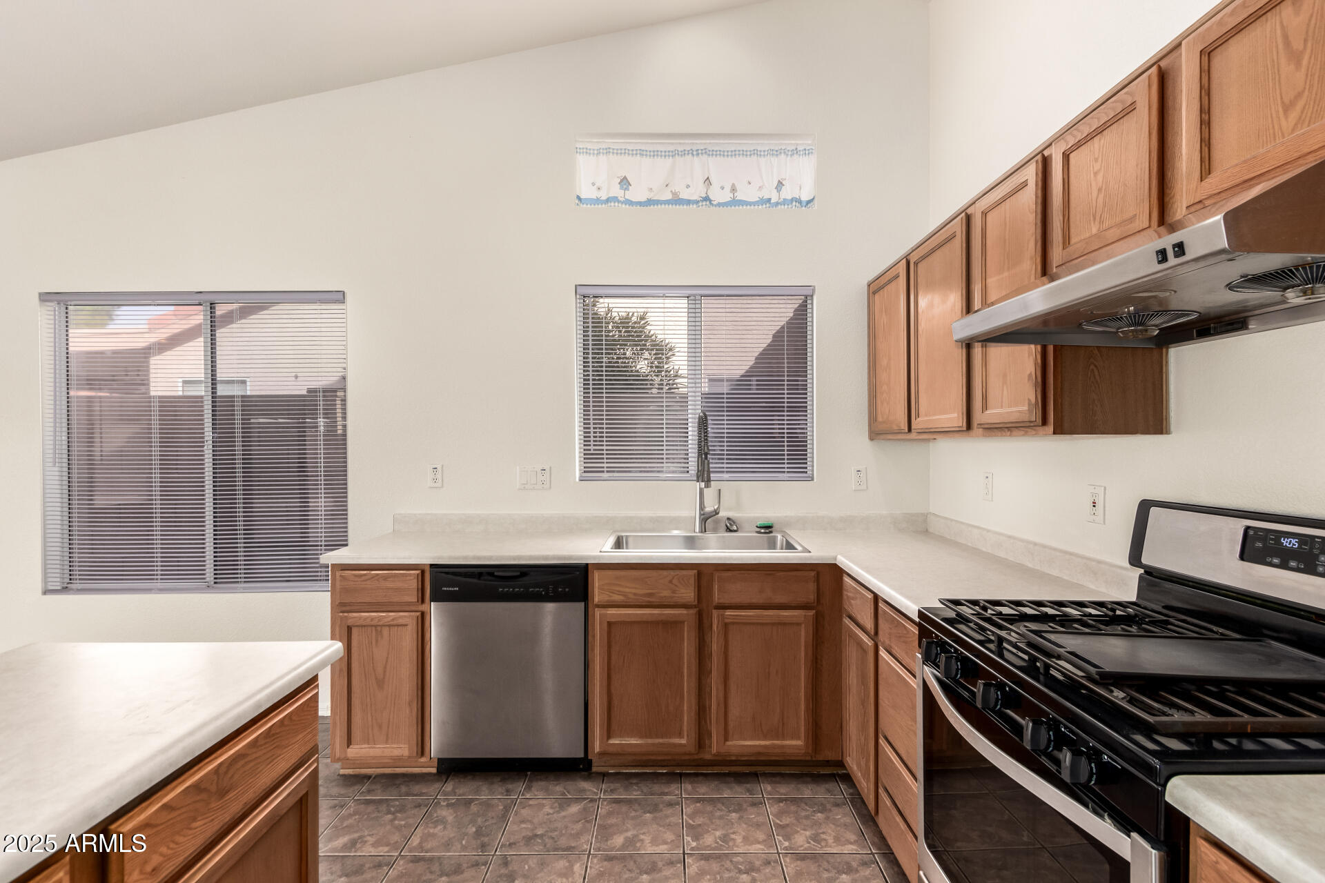 4010 West Wethersfield Road Phoenix, AZ 85029 - Photo 16 of 43 a kitchen that has a sink and a stove