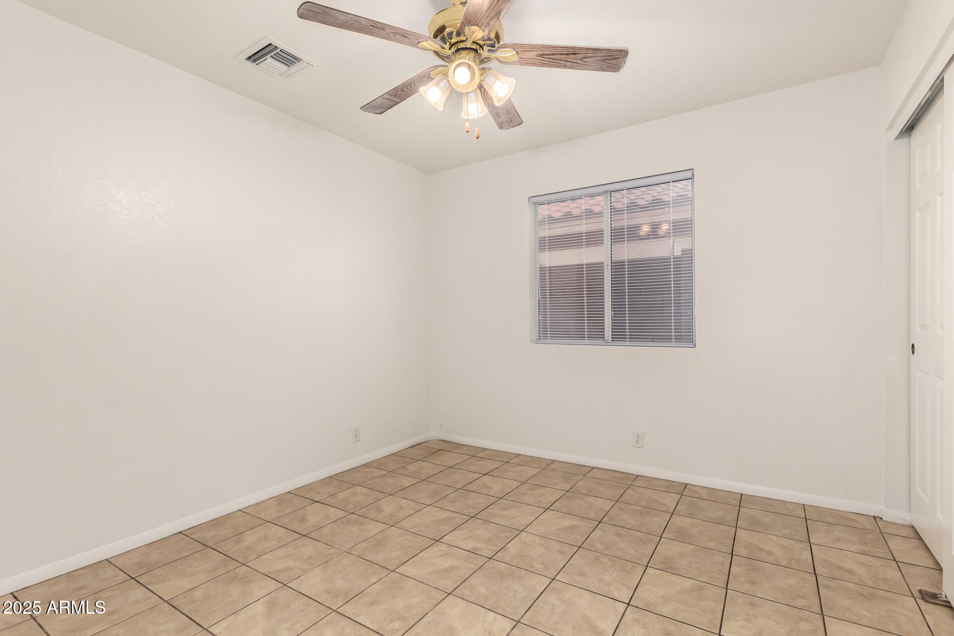 4010 West Wethersfield Road Phoenix, AZ 85029 - Photo 27 of 43 an empty room with windows and fan