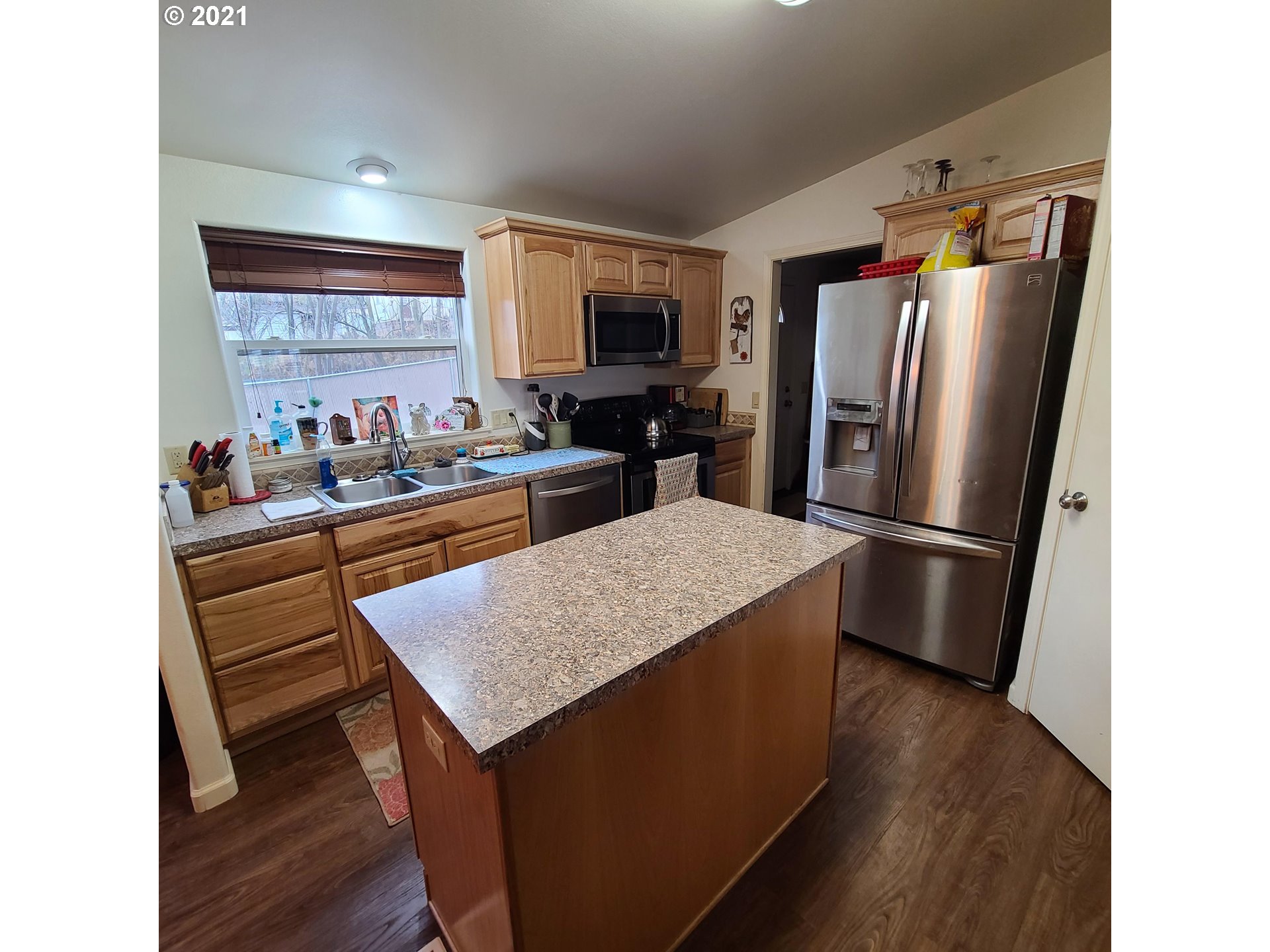 3033 Southwest River View Drive Pendleton, OR 97801 - Photo 8 of 32 a kitchen with stainless steel appliances a refrigerator and a stove