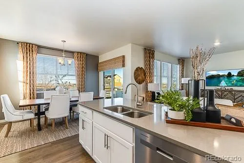 a kitchen with sink and view of living room