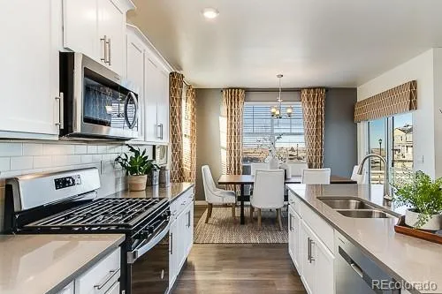 a kitchen with sink stove and cabinets