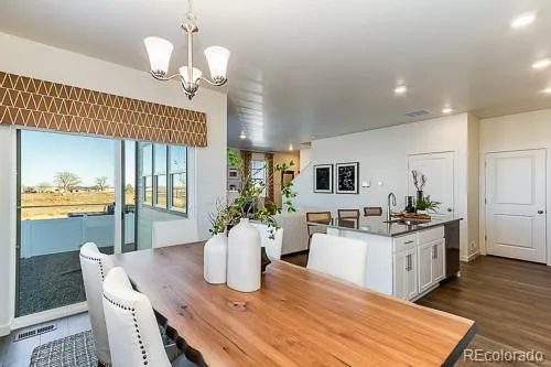 a kitchen with sink and view of living room
