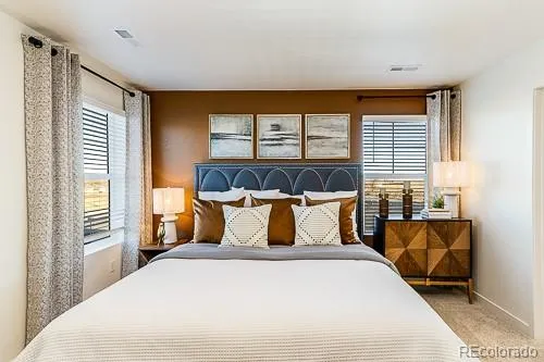 a bedroom with a large bed and a large window