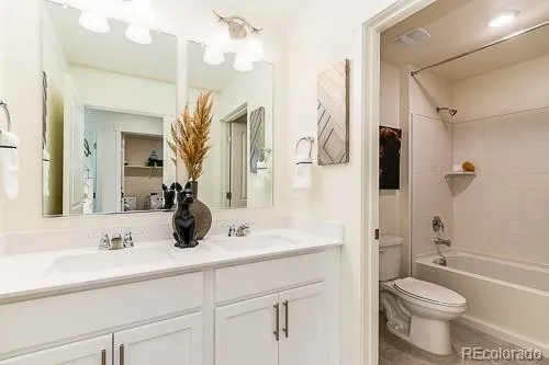 a bathroom with a sink a toilet a mirror and shower