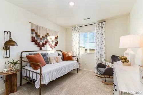 a living room with furniture a couch and a window