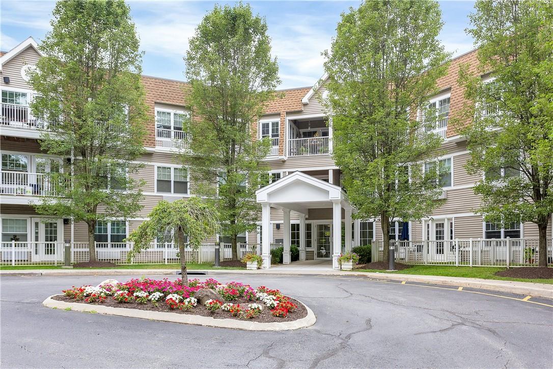 110 Sutton Drive Mount Kisco, NY 10549 - Photo 1 of 1 a view of a white house with large windows next to a road