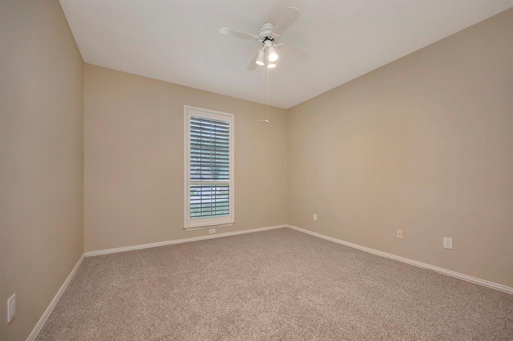 4008 Ramsgate Court Colleyville, TX 76034 - Photo 18 of 33 2nd bedroom downstairs neutral wall tones, textured carpeting, and white baseboards