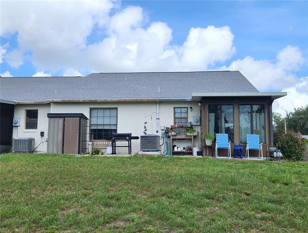 1701 Southeast 24th Road, Unit 1601 Ocala, FL 34471 - Photo 27 of 30 a view of a house with a yard and sitting area