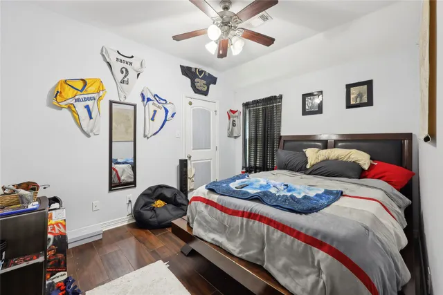 a bedroom with bed and a chandelier