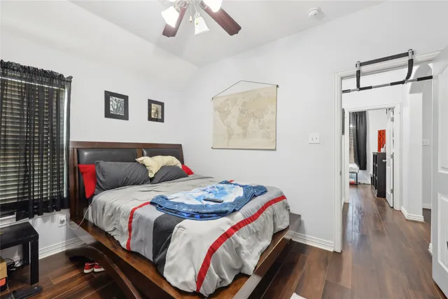 a bedroom with bed and a chandelier