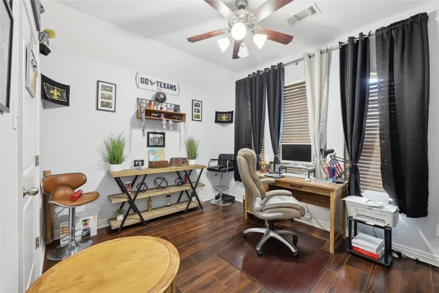 a view of a workspace with furniture and a window