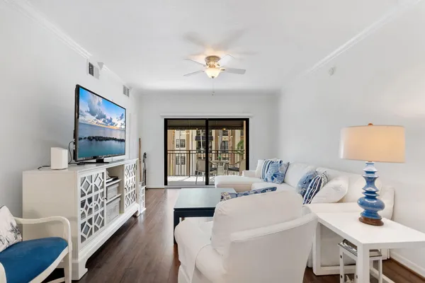 a living room with furniture a chandelier and a table
