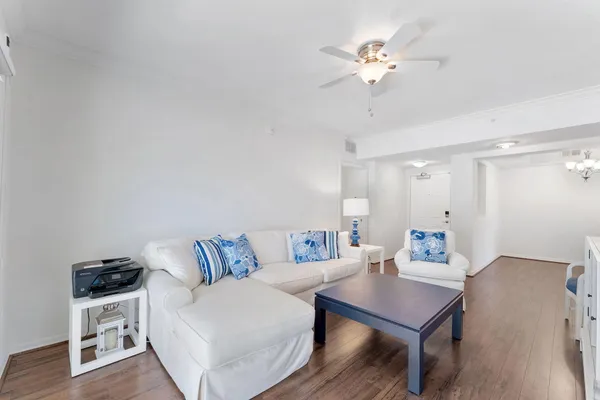 a living room with furniture a flat screen tv and a table